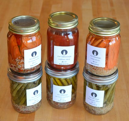 Jars of TWCannings salsa, pickled carrots and pickled green beans